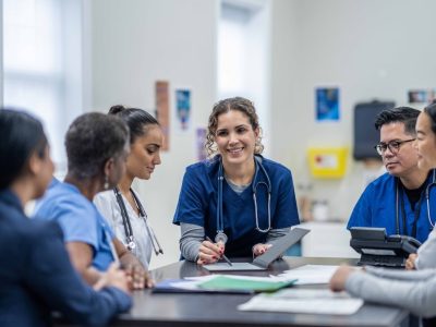 Image of group of clinicians meeting around a table.