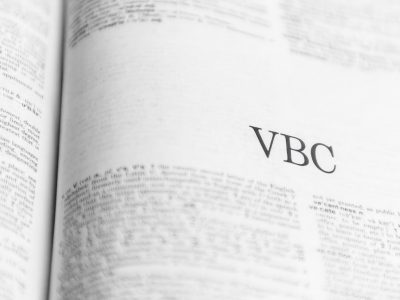 Image of dictionary displaying "VBC" Image generated by Chatgpt for banner image of VBC vs FFC.
